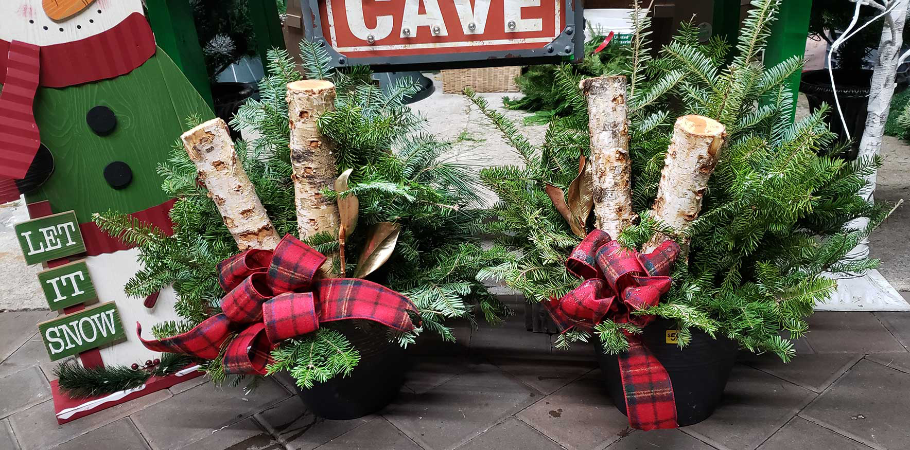 Holiday decor display with logs bows and ribbons